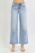 RISEN Full Size Tummy Control High Rise Crop Wide Leg Jeans in light wash, featuring relaxed wide-leg cut and contemporary cropped length.