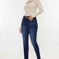 Woman wearing Mid Rise Gradient Skinny Jeans and beige long-sleeve top, showcasing a trendy and stylish look.