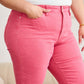 Woman wearing Crop Dylan Full Size Tummy Control High Waist Raw Hem Jeans in pink, showcasing stylish raw hem design and comfortable fit