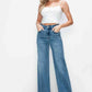 Model showcasing bytos Full Size High Rise Wide Leg Jeans with Pockets paired with a white cropped top.