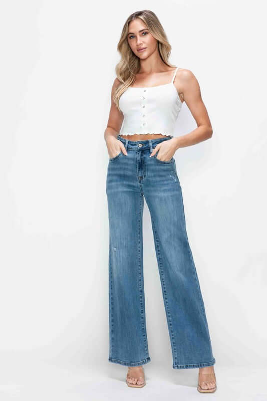 Model showcasing bytos Full Size High Rise Wide Leg Jeans with Pockets paired with a white cropped top.