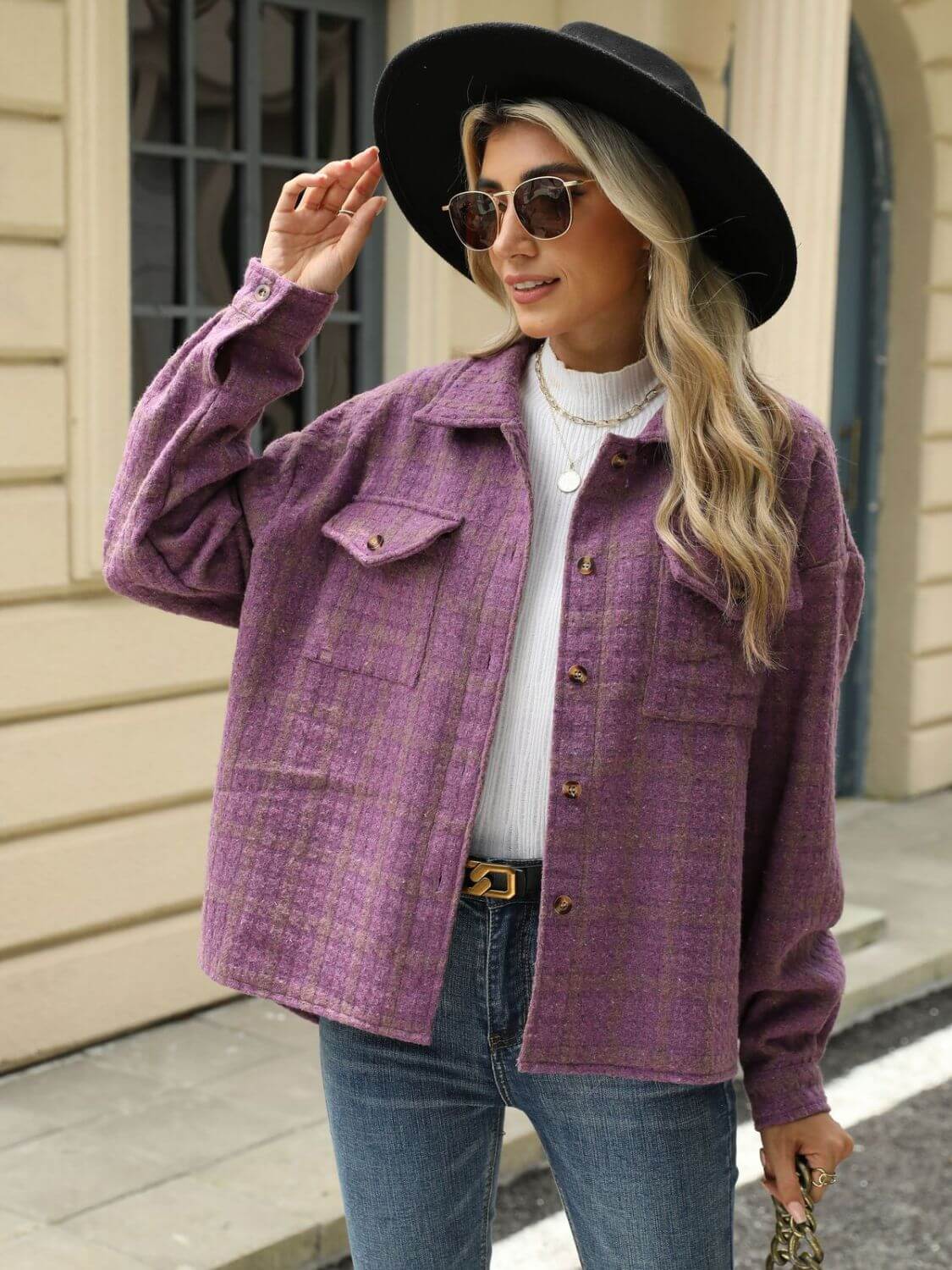 Woman wearing Bella Road Plaid Collared Neck Long Sleeve Jacket in purple with jeans and a black hat.