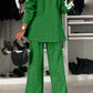 Woman in a green two-piece suit with white stripes, showcasing a stylish back view in a chic closet setting.