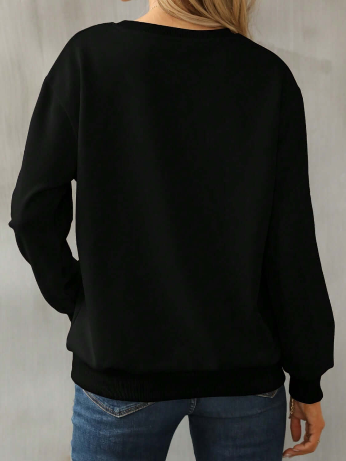 Back view of Bella Road Yellowstone Round Neck Long Sleeve Sweatshirt in black, showcasing cozy style and comfortable fit.