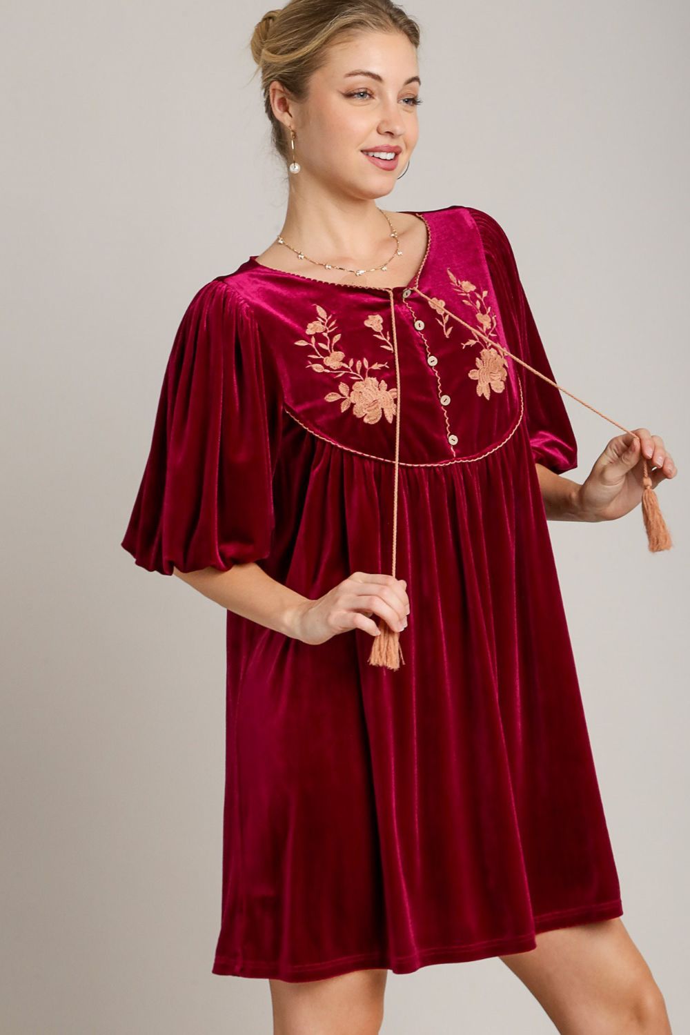 Stunning Umgee embroidered velvet mini dress in wine red with tassels, perfect for elegant occasions and special events.