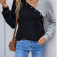 Woman wearing Perfee Decorative Button Contrast Long Sleeve Sweatshirt in black with stylish buttons and casual jeans.