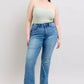 Model showcasing high waist tummy control vintage wash side slit slim bootcut jeans with a light green top.