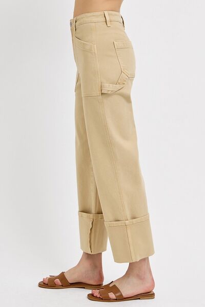 Side view of RISEN high rise wide straight cuffed patch jeans in beige, showcasing relaxed fit and cuffed bottoms.