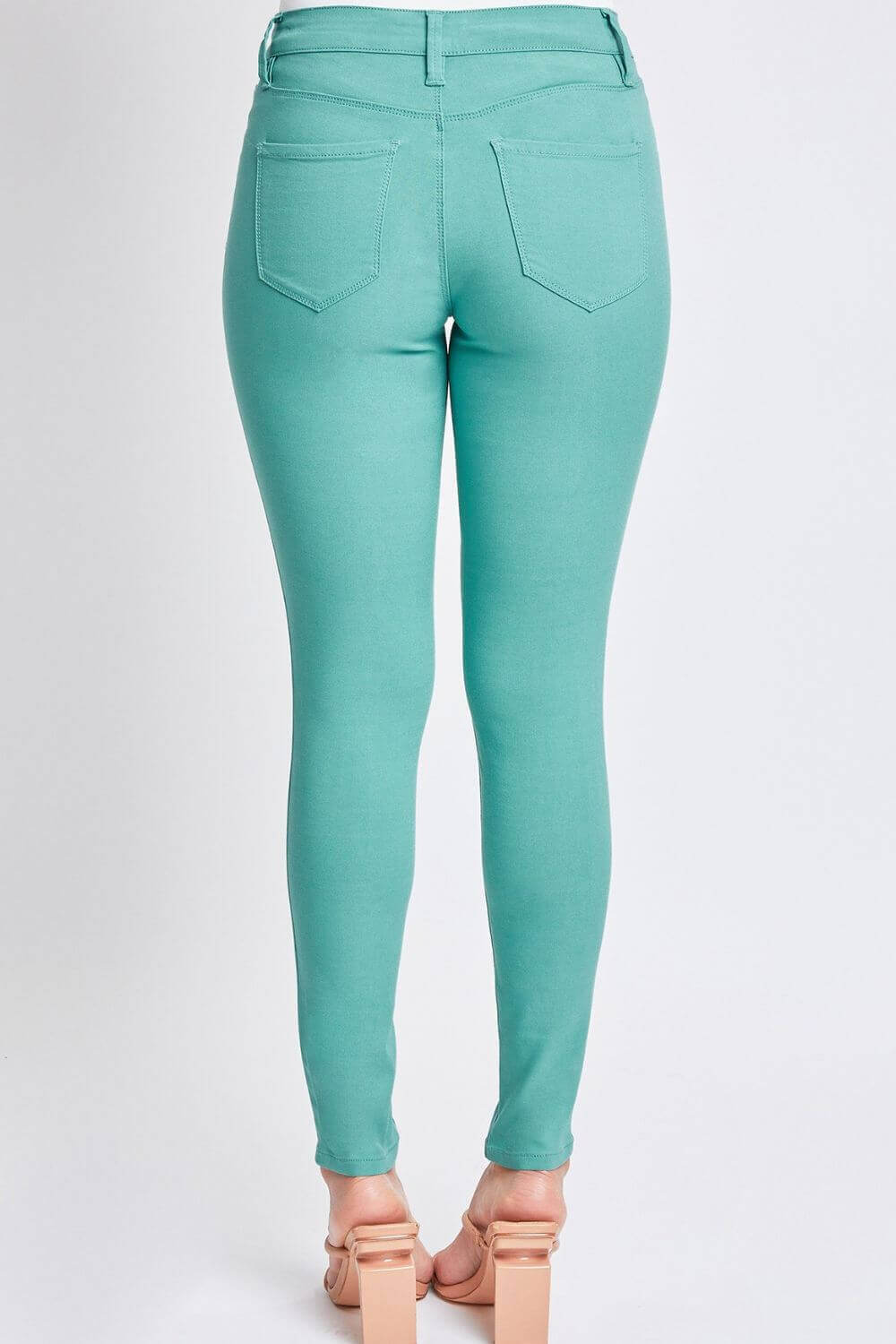 Back view of mint green Hyperstretch Mid-Rise Skinny Pants by YMI Jeans, showcasing sleek and flexible fit for versatile style.