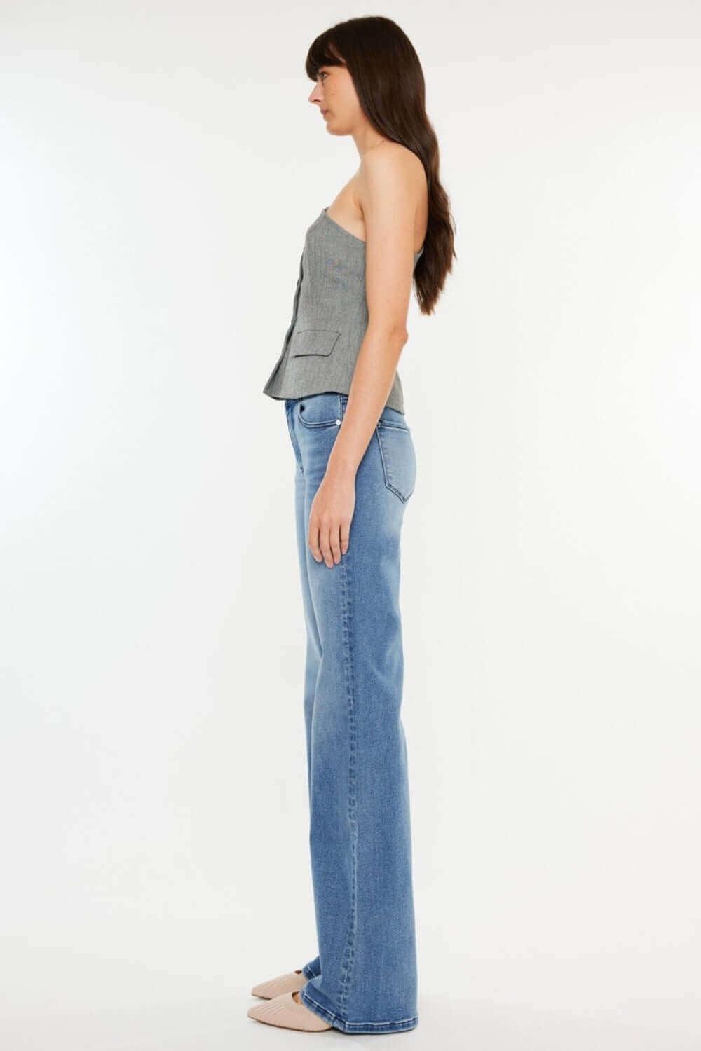 Side view of a woman wearing Ultra High Rise Cat's Whiskers Jeans with a high-waisted silhouette and vintage detailing.