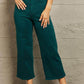 Woman wearing Hailey Full Size Tummy Control High Waisted Cropped Wide Leg Judy Blue Jeans in teal color