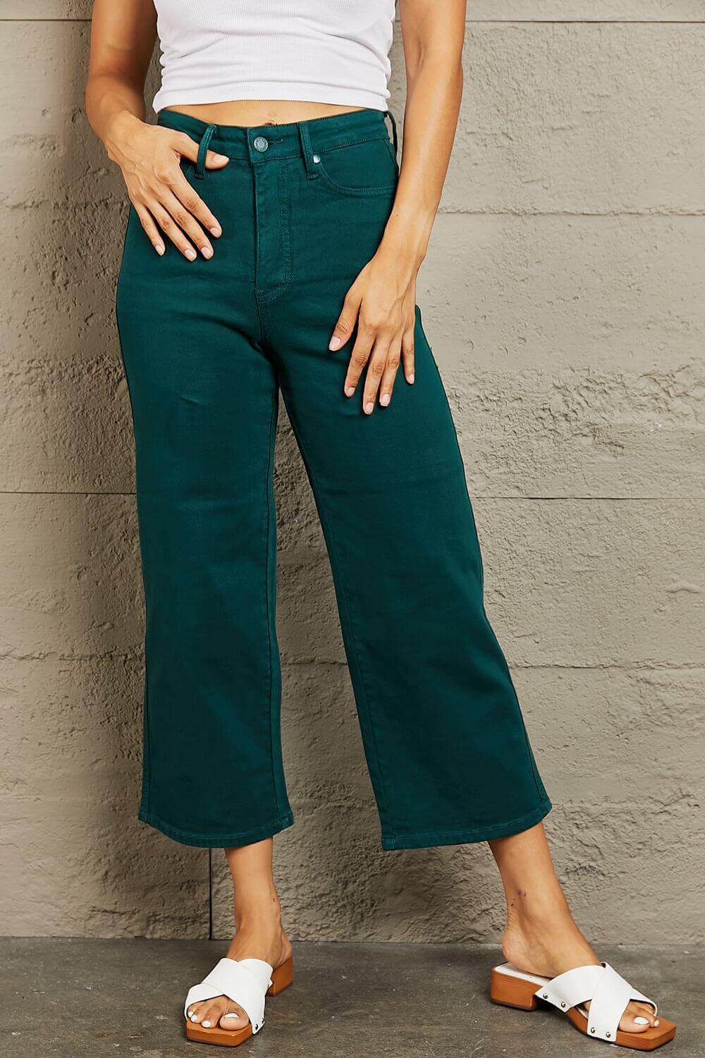 Woman wearing Hailey Full Size Tummy Control High Waisted Cropped Wide Leg Judy Blue Jeans in teal color