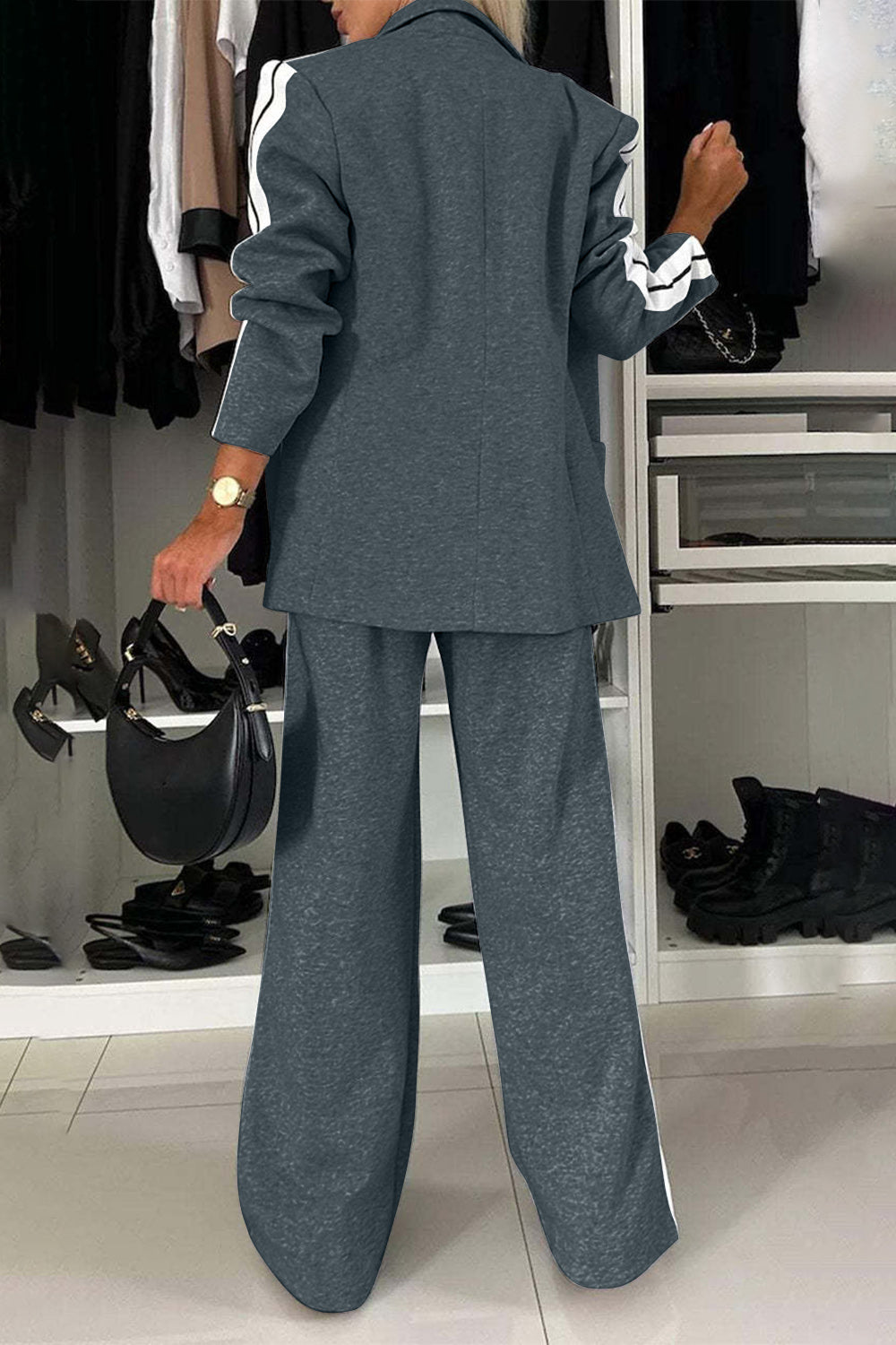 Woman in a stylish gray two-piece set with a contrast lapel collar and wide-leg pants, showcasing a chic back view.