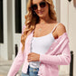 Woman wearing Bella Road Button Up Long Sleeve Cardigan in pink, stylishly paired with sunglasses, a white cami, and blue jeans.