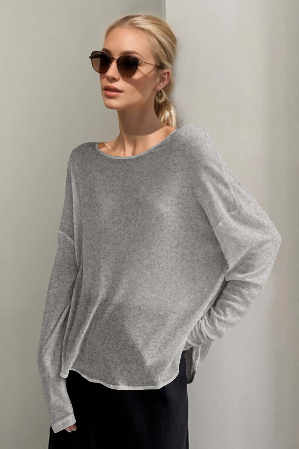 Stylish woman in gray Basic Bae High-Low Long Sleeve T-Shirt with sunglasses, exuding modern monochrome vibes.