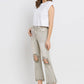 Woman wearing Lovervet distressed raw hem cropped flare jeans with a white tee and heels