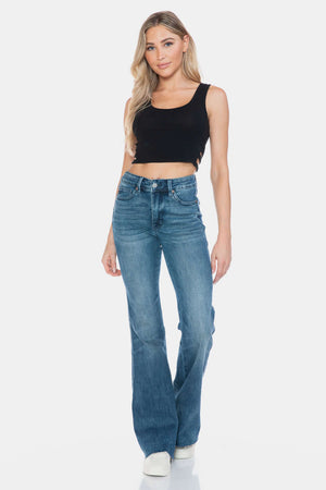 Woman wearing Judy Blue Full Size Tummy Control Cut Hem Flare Jeans with vintage wash, showcasing a stylish and flattering fit.