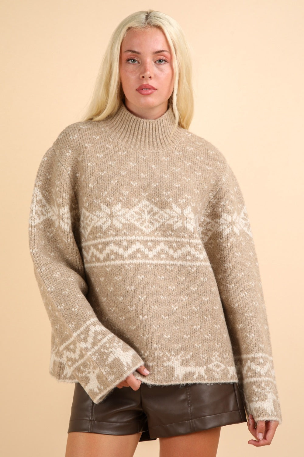 Festive beige sweater with snowflake pattern and mock neck, perfect for cozy winter gatherings and spreading holiday cheer