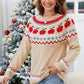 Woman wearing an angel wings graphic round neck sweater with apple designs, perfect for a whimsical winter look.