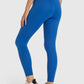 A woman wearing blue high waist ankle-length yoga leggings, showcasing a comfortable fit perfect for workouts.