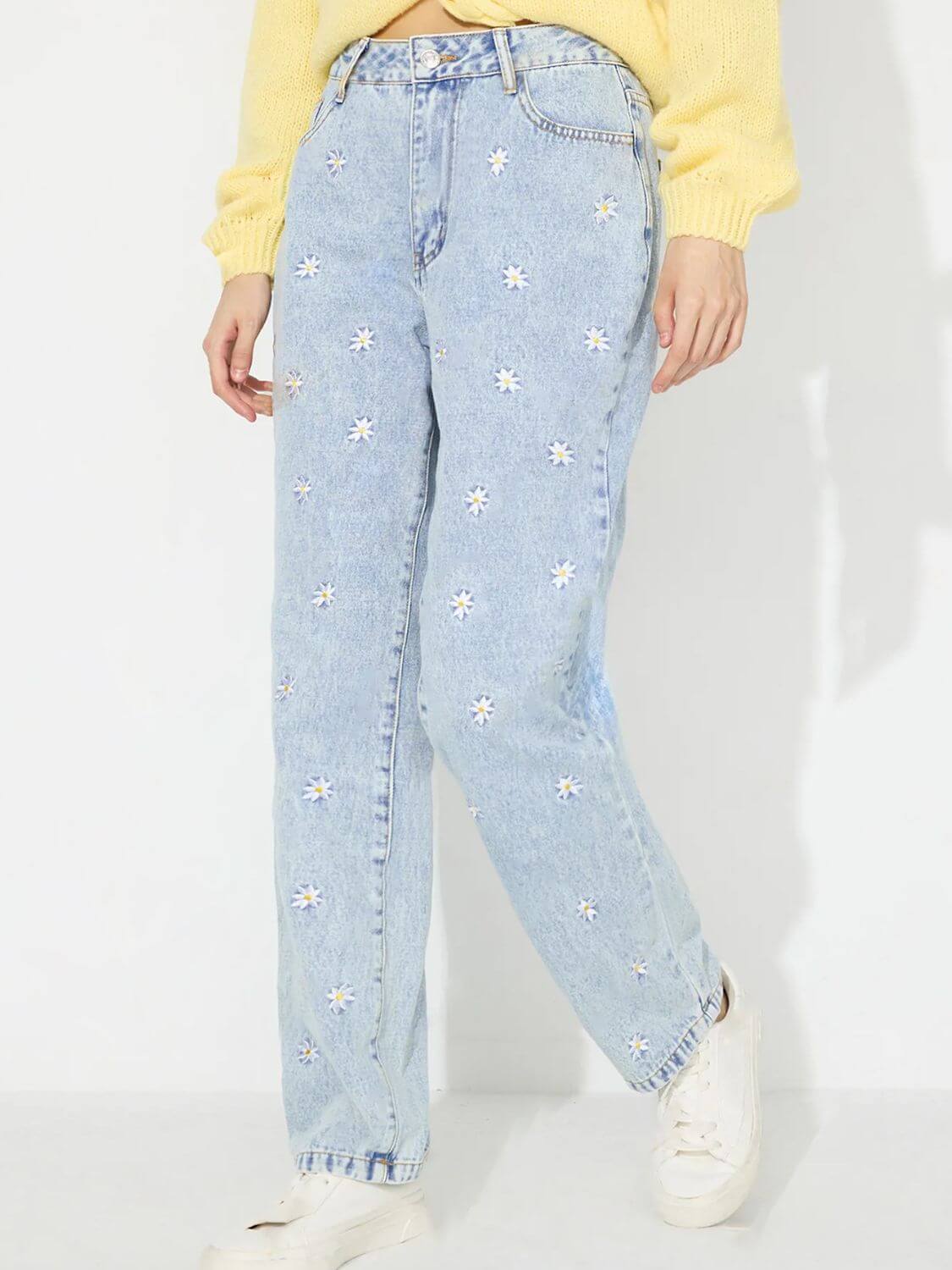 Bella Road Daisy Straight Jeans with Pockets, buttoned and floral-patterned, styled with a yellow top and white sneakers.