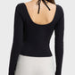 Back view of Millennia Halter Neck Long Sleeve Sporty Top, featuring a stylish tied design and sleek black fabric.