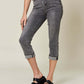 Woman wearing Judy Blue Jeans Button Fly High Waist Cuffed Capris with trendy cuffed hem and black sandals.