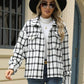 Woman in Bella Road Plaid Collared Neck Long Sleeve Jacket with black hat and sunglasses, standing in front of a building.