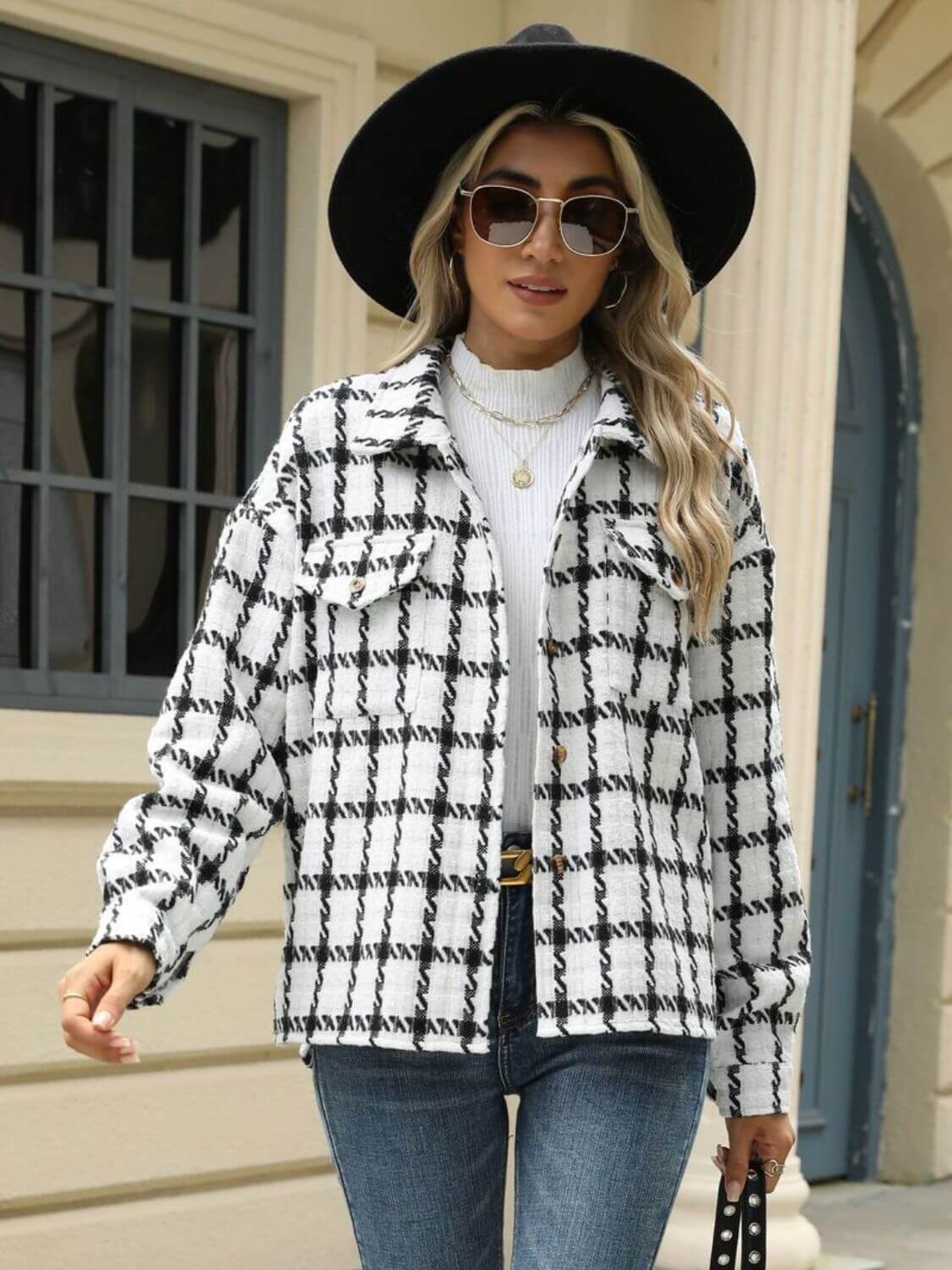 Woman in Bella Road Plaid Collared Neck Long Sleeve Jacket with black hat and sunglasses, standing in front of a building.