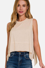 Woman wearing Exposed Seam Slit Round Neck Tank in beige with trendy exposed seams and slit details, paired with blue jeans and styled casually.