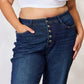 Woman wearing high waist button-fly straight Judy Blue Jeans with a white crop top.