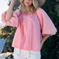 Woman wearing a pink Poplin Bubble Sleeve Blouse paired with white shorts and a straw hat outdoors.