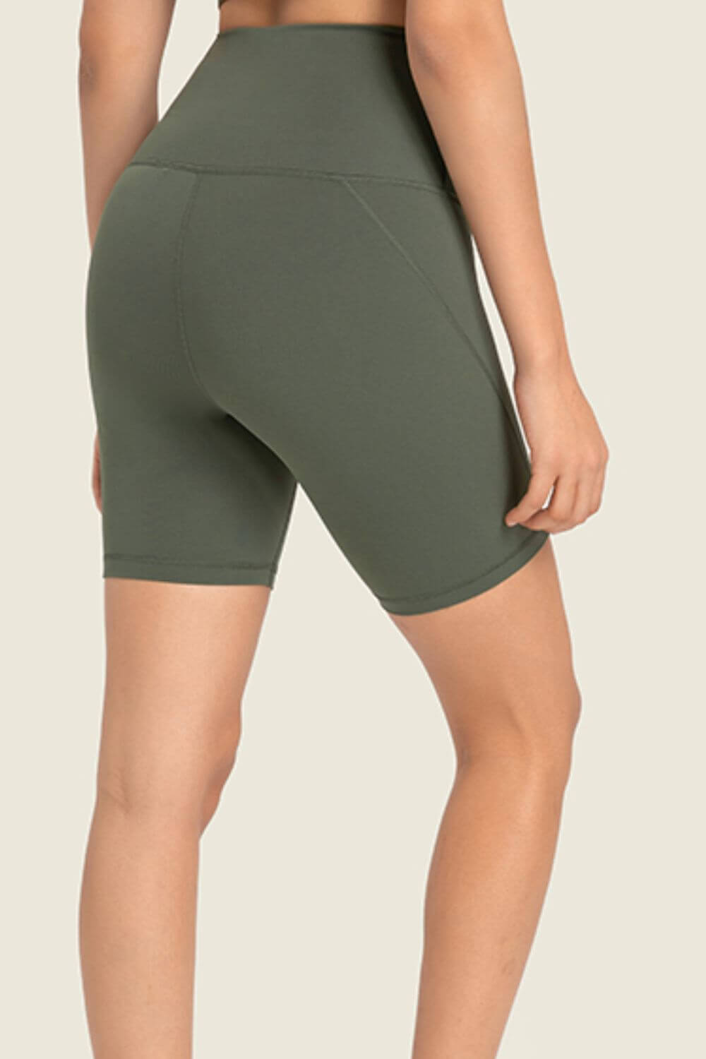 Millennia seamless high-rise wide waistband biker shorts in green, showcasing a smooth and supportive fit from the back.