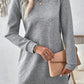 Stylish woman in a gray textured long sleeve mini dress holding a clutch, perfect for casual outings.