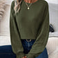 Woman wearing Bella Road Ribbed Round Neck Lantern Sleeve T-Shirt in green with jeans, showcasing ribbed texture and playful lantern sleeves.