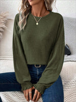 Woman wearing Bella Road Ribbed Round Neck Lantern Sleeve T-Shirt in green with jeans, showcasing ribbed texture and playful lantern sleeves.