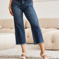 Woman wearing Tummy Control High Waist Raw Hem Jeans by RFM, showing stylish and flattering tummy control fit with a trendy raw hem detailing.