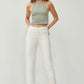 Woman wearing RISEN full size high waist rolled hem straight jeans in white paired with a green tank top.