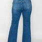 Woman wearing bytos Cat's Whiskers mid-rise ankle jeans, showcasing a flattering fit and stylish design from the back.