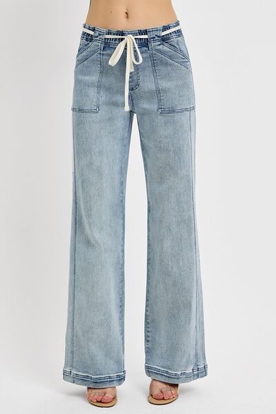 RISEN plus size straight leg jeans with pockets, featuring a drawstring waist and a stylish light wash.