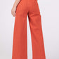 Wide leg cropped pants in red with back pockets and an adjustable button closure for a modern and comfortable fit.