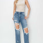 Model wearing High Rise Distressed Crop Straight Risen Jeans with edgy detailing and flattering fit