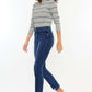 Model wearing High Rise Slim Straight Jeans paired with a striped shirt and sneakers, showcasing a sleek, modern silhouette.