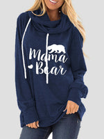 Woman wearing a navy blue hoodie with "Mama Bear" graphic and drawstrings.