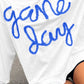 Woman wearing a Bella Road Game Day Round Neck Long Sleeve Sweatshirt with "game day" written in blue letters