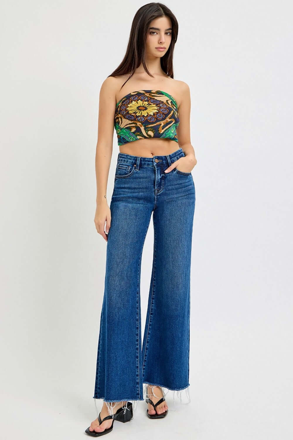 Model wearing RISEN Tummy Control High Rise Wide Leg Jeans with trendy top, showcasing stylish fit and pockets.