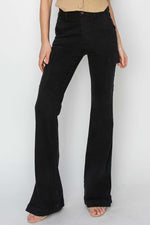 High-rise side slit cargo bootcut jeans in black with a trendy bootcut leg, utilitarian cargo pockets, and edgy side slits by Risen Jeans.