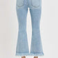 Back view of RISEN plus size raw hem distressed cropped flare jeans in light blue.