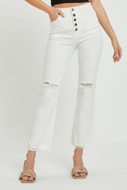 Woman wearing high rise button fly straight ankle jeans by Risen Jeans with vintage charm and distressed details