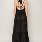 Back view of a black HYFVE halter neck maxi dress with tie-back and tiered silhouette, perfect for warm days.